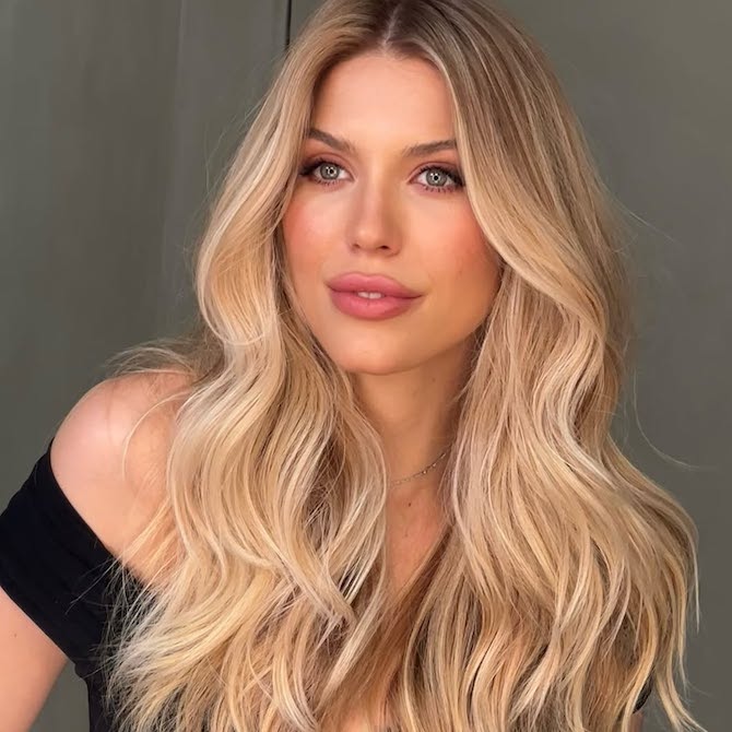 Woman with sun-kissed honey blonde balayage waves