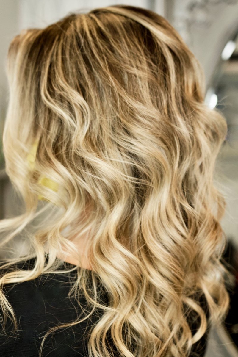 Medium length hair with layered honey blonde curls