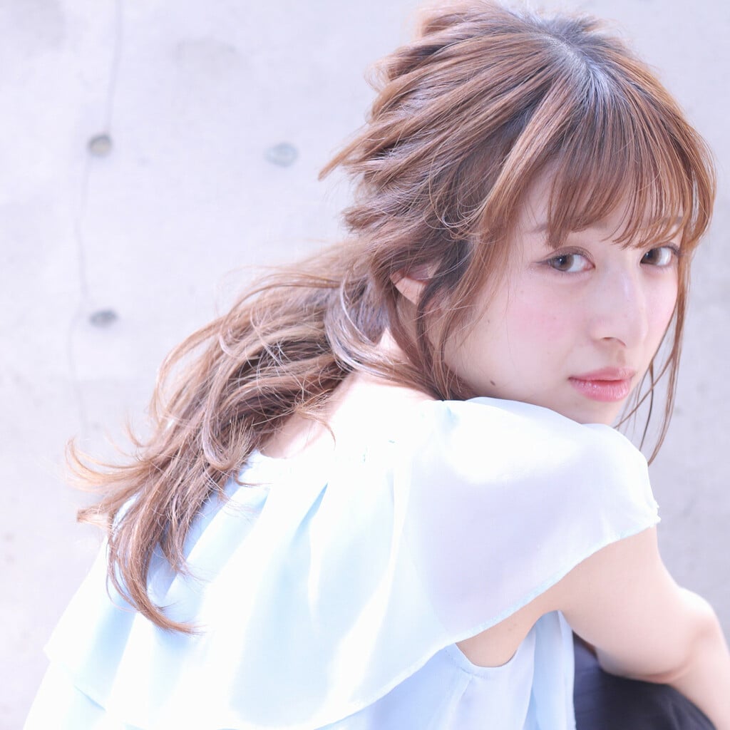 Casual high ponytail paired with light Korean wispy bangs and loose side tendrils