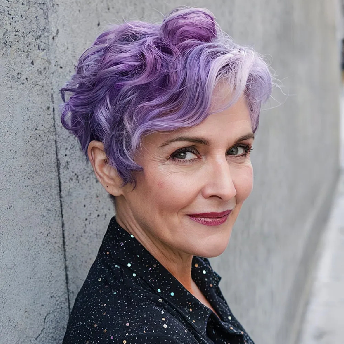 Playful purple lavender wavy pixie cut on a mature woman