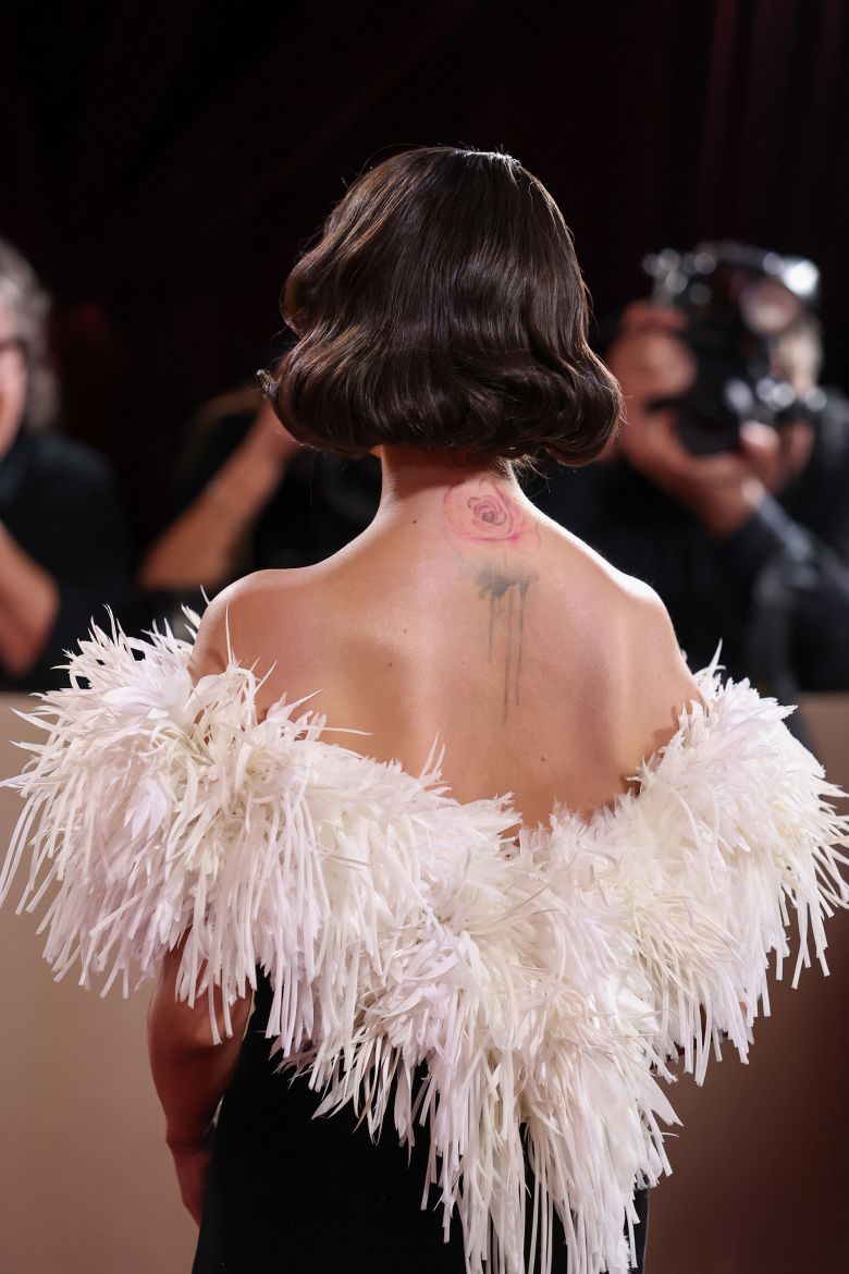 Selena Gomez from behind showing her sculpted vintage bob and back tattoo