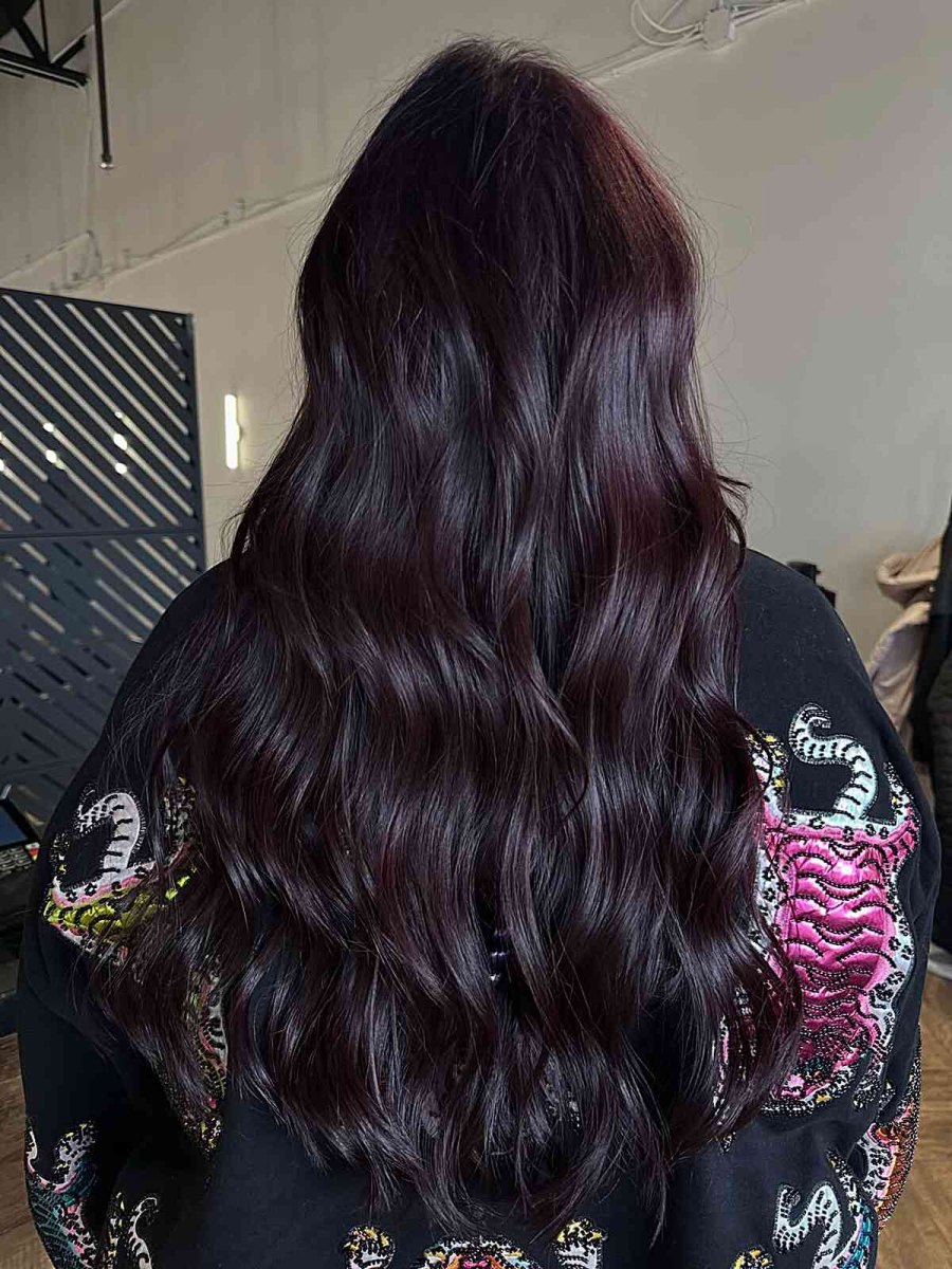 Long dark black hair with subtle black cherry waves and layering