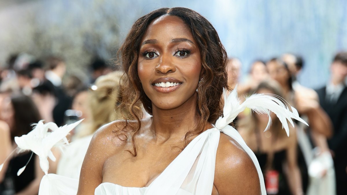 Ayo Edebiri at the Met Gala with soft face-framing curls and feather details