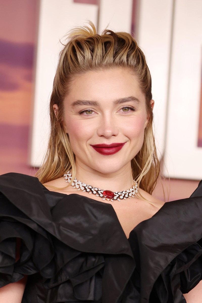 Florence Pugh with a voluminous slicked-back blonde hairstyle