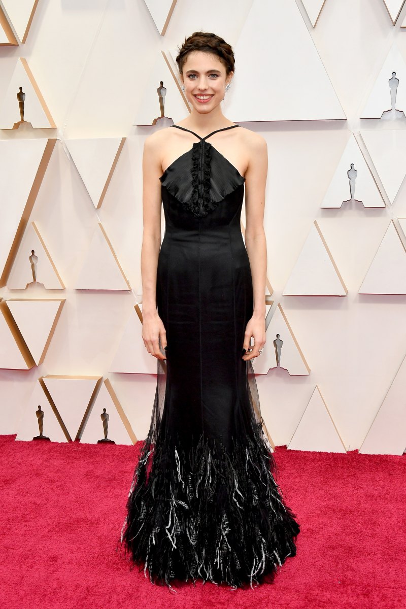 Margaret Qualley posing on the red carpet with a braided updo