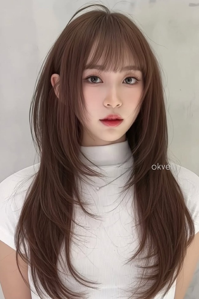 Soft Korean wolf cut featuring airy long layers and textured wispy bangs