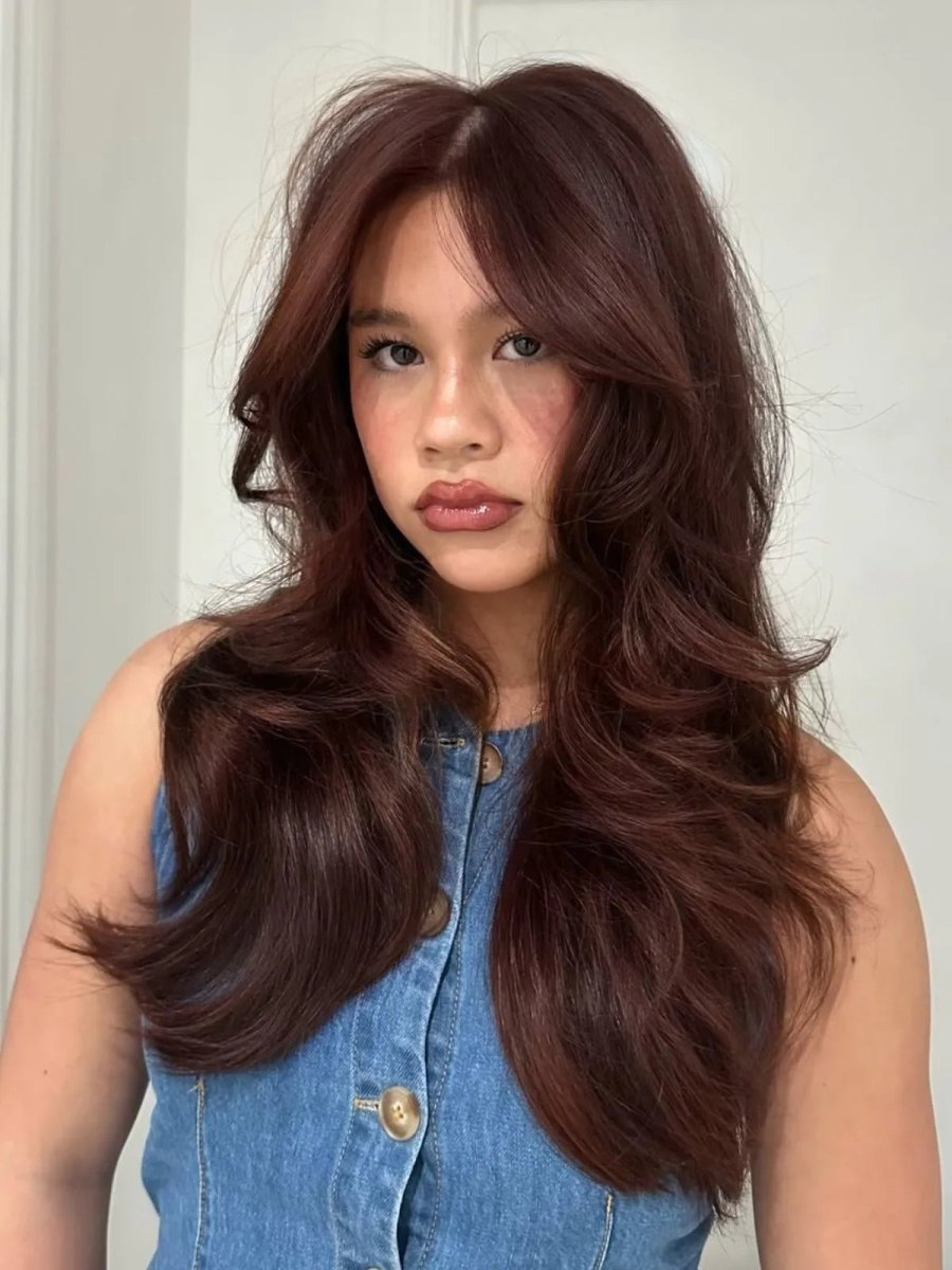 Bouncy 90s blowout with wine red and dark chocolate brunette layers