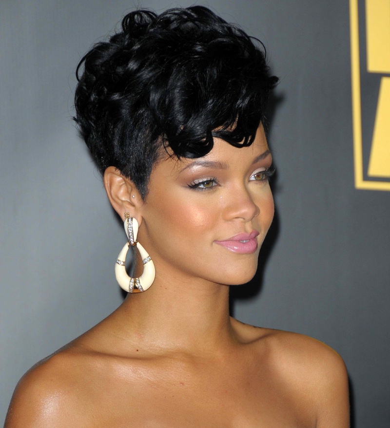 Glamorous black stacked curly pixie with soft tendrils on the forehead