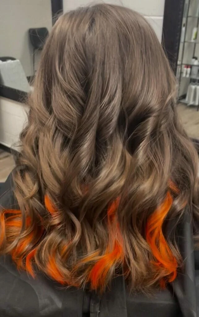 Light Orange Under-Dye Curls on Dark Blonde Hair